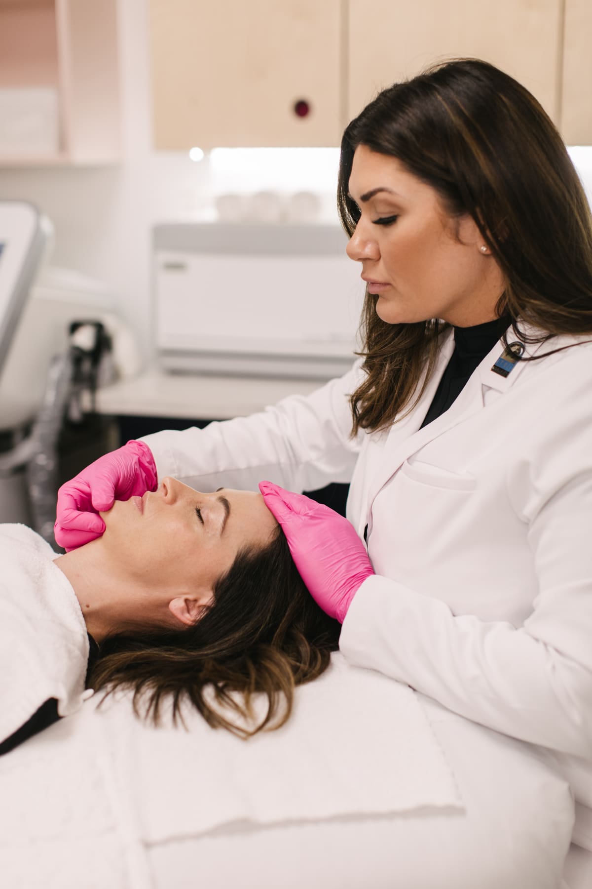 Woman receiving facial beauty treatment.